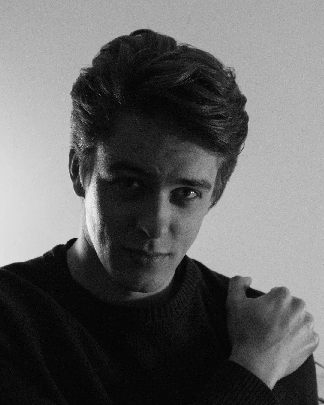Black and white portrait of Joep Swagemakers in a dark sweater, one hand on his shoulder